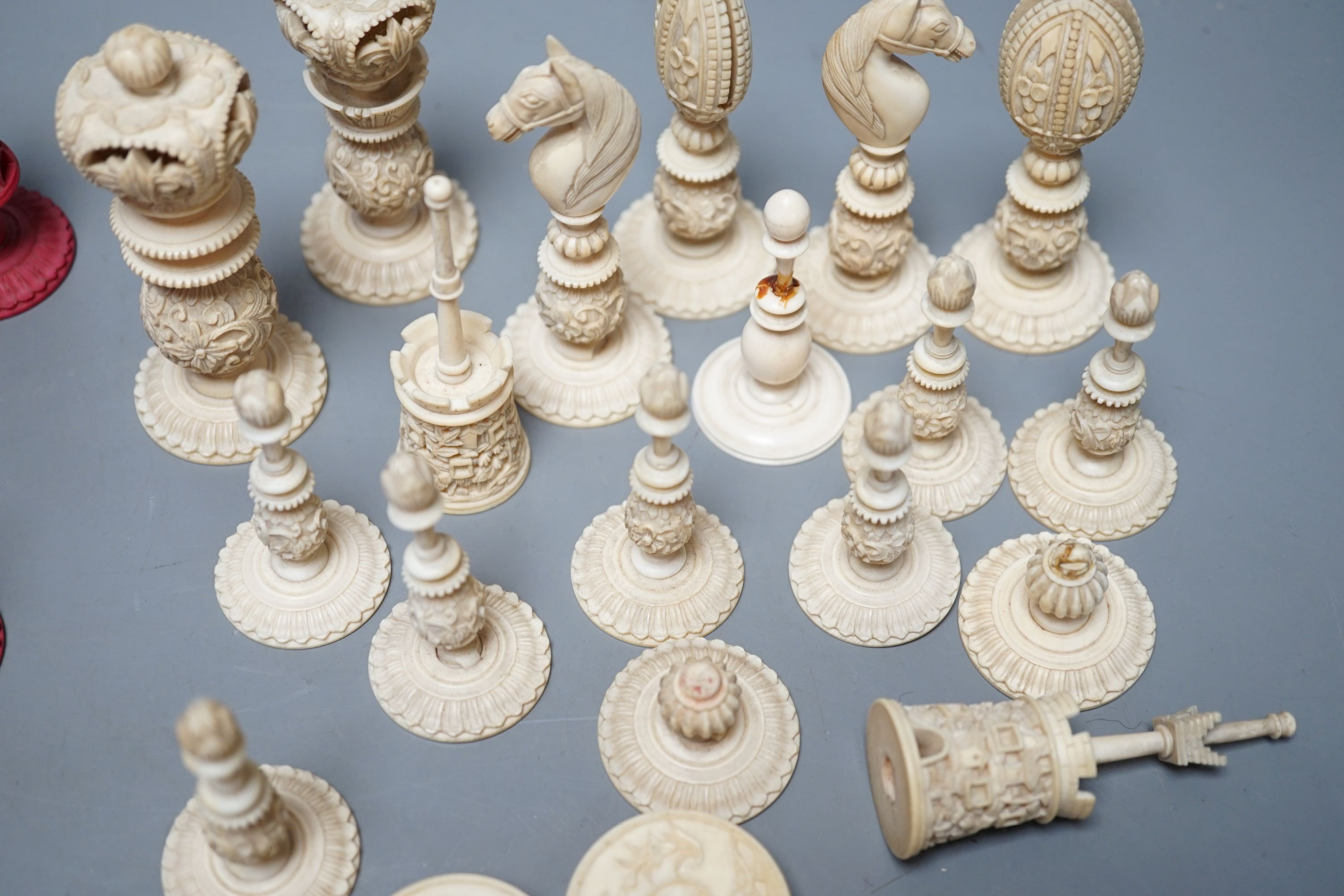 A 19th century Chinese export Burmese pattern carved and stained ivory chess set, one white pawn associated